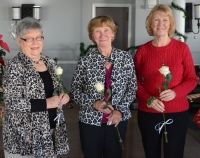 3 women with white roses